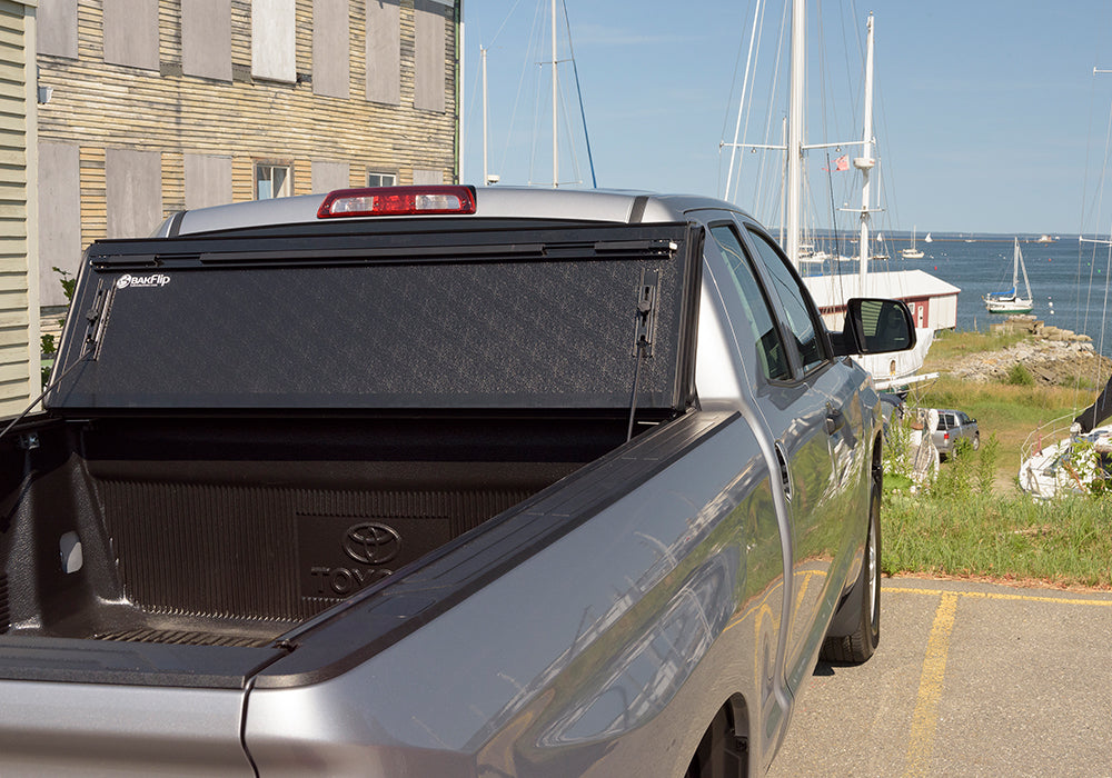 BAK BAKFlip G2 Hard Folding Truck Bed Cover - Rail Mounts Near Top of Bed Rail - Rails Can Be Lowered Using Drop Down Brackets - 2007-2021 Toyota Tundra 5' 6" Bed with Deck Rail System without Trail Special Edition Storage Boxes Model 226409T